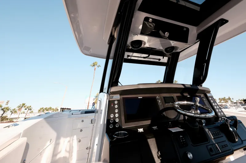Slide: The Image of 2024 Robalo R360 Center Console boat interior with modern dashboard and steering wheel. - 15