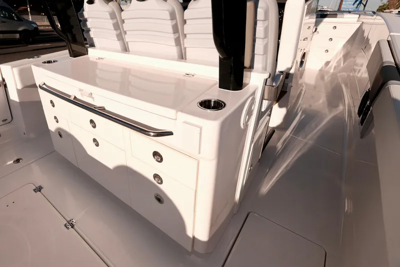 Slide: The Image of 2024 Robalo R360 Center Console boat interior with sleek white seating and storage. - 20
