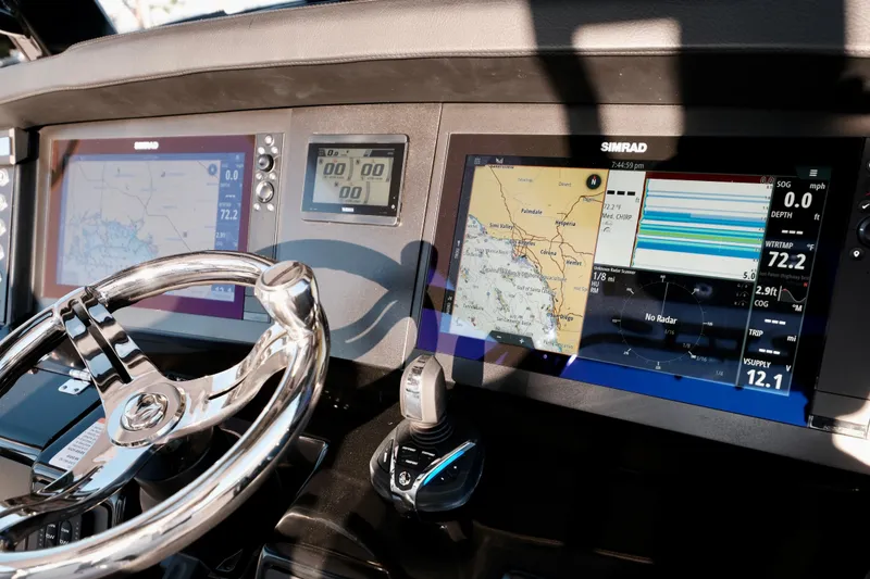 Slide: The Image of 2024 Robalo R360 Center Console dashboard with navigation screens and steering wheel. - 26