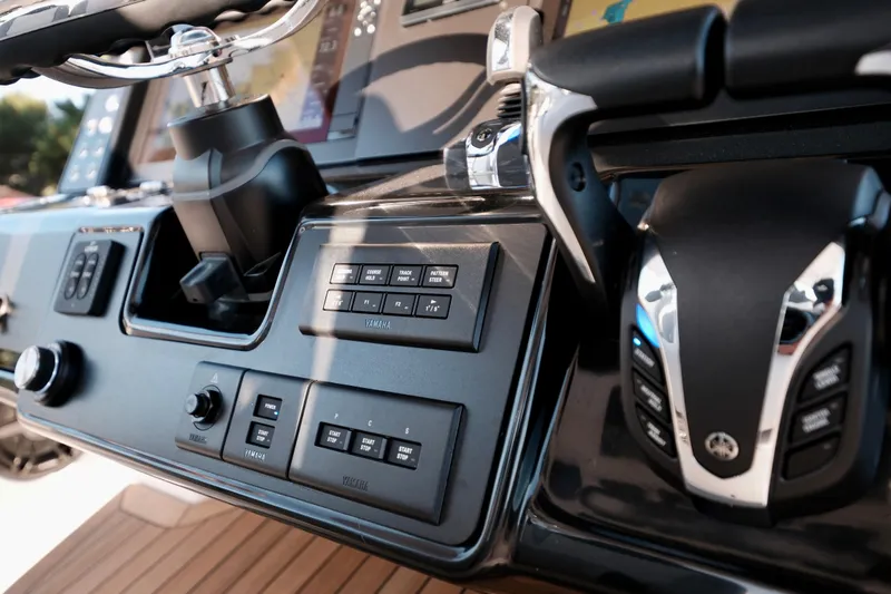 Slide: The Image of 2024 Robalo R360 Center Console dashboard with advanced controls and steering wheel. - 27