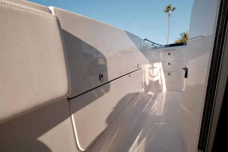 Slide: The Image of 2024 Robalo R360 Center Console interior with sleek white design and storage compartments. - 32