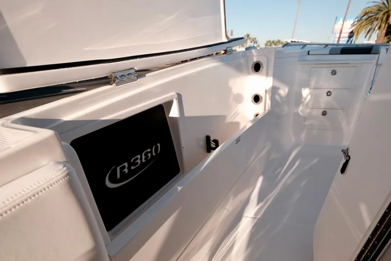 Slide: The Image of 2024 Robalo R360 Center Console interior with storage compartments and sleek design. - 33