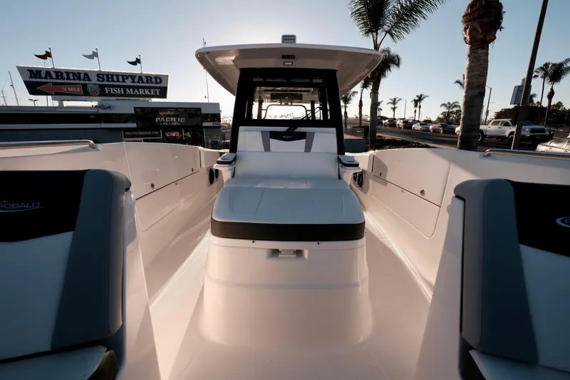 Slide: The Image of 2024 Robalo R360 Center Console boat at marina, palm trees in background. - 43