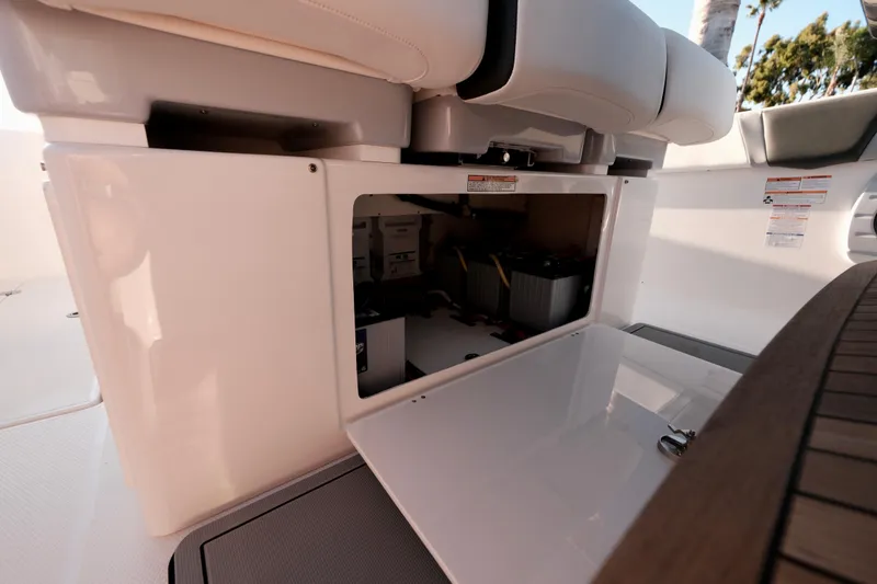 Slide: The Image of 2024 Robalo R360 Center Console storage compartment with open hatch, showcasing interior space. - 45