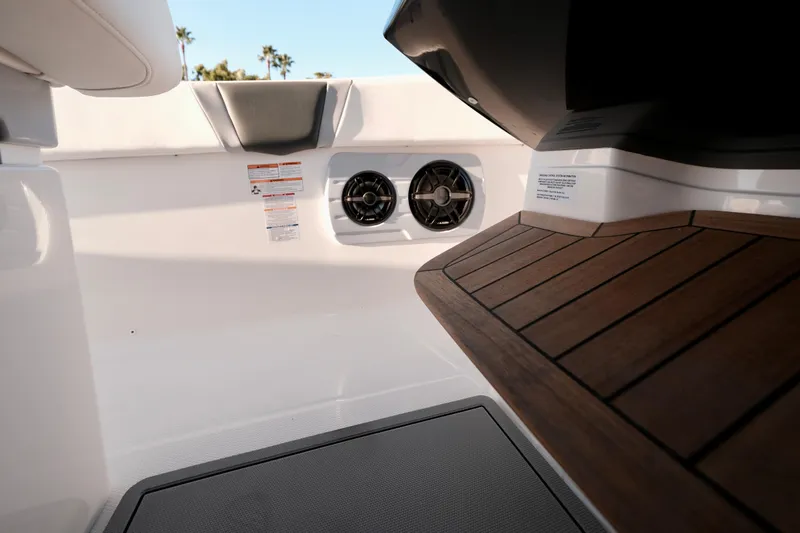 Slide: The Image of 2024 Robalo R360 Center Console interior with teak flooring and speaker system. - 47