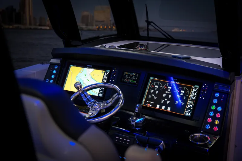 Slide: The Image of 2024 Robalo R360 Center Console dashboard with illuminated navigation and control screens. - 52