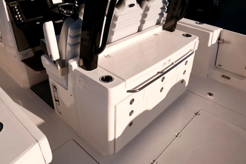 Slide: The Image of 2024 Robalo R360 Center Console boat interior with seating and storage compartments. - 9
