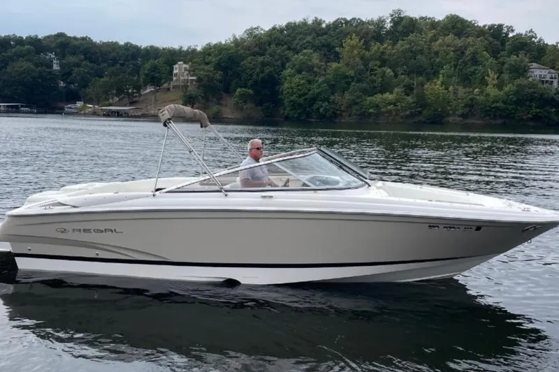 The Image of 2008 Regal 2700 Bowrider boat on a lake with lush green shoreline. - 0