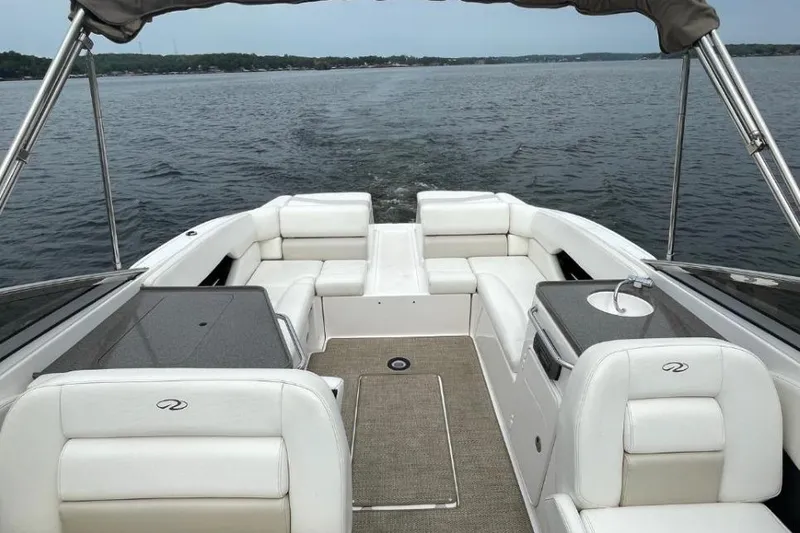 Slide: The Image of 2008 Regal 2700 Bowrider boat interior with white seating and lake view. - 2