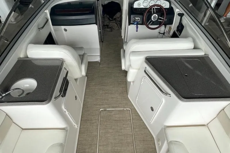 Slide: The Image of 2008 Regal 2700 Bowrider interior with white seating and sleek dashboard design. - 5