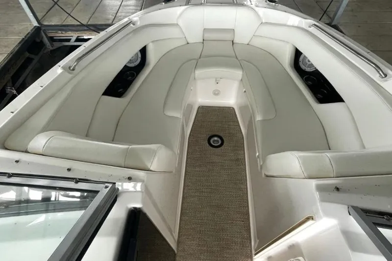 Slide: The Image of 2008 Regal 2700 Bowrider interior with white seating and carpeted floor. - 7
