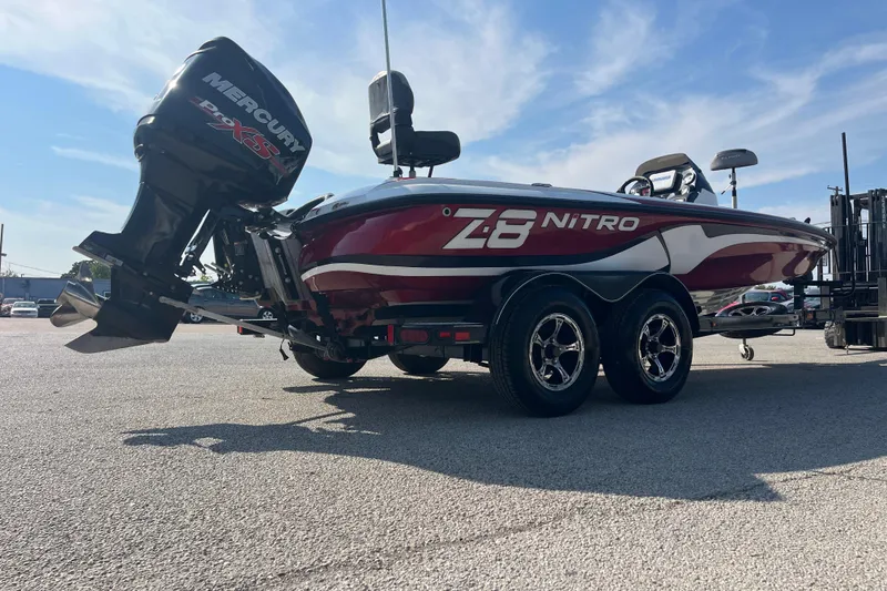 Slide: The Image of 2015 Nitro Z-8 boat on trailer, red and white hull, parked outdoors. - 16