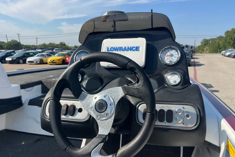 Slide: The Image of 2015 Nitro Z-8 boat seat and console, outdoor setting, clear blue sky. - 18
