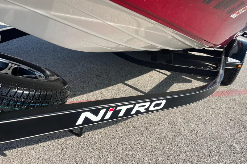 Slide: The Image of 2015 Nitro Z-8 boat on trailer by a lake under a blue sky. - 2