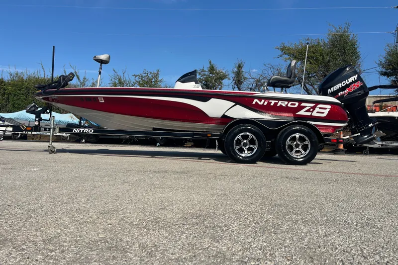 Slide: The Image of 2015 Nitro Z-8 boat on trailer by a lake under a blue sky. - 23