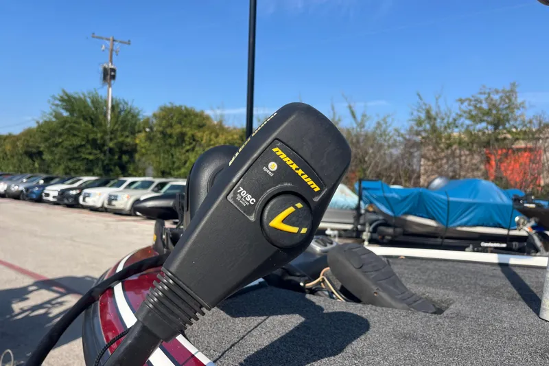 Slide: The Image of Mercury Pro XS outboard motor on a 2015 Nitro Z-8 boat, parked outdoors. - 24