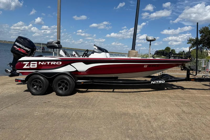 Slide: The Image of Close-up of a 2015 Nitro Z-8 boat deck with gray carpet and storage compartments. - 47