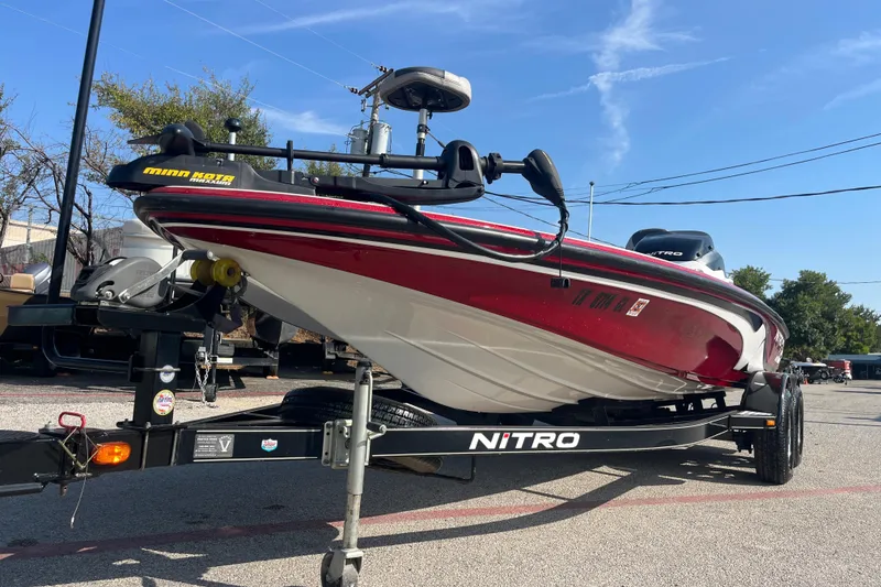 Slide: The Image of 2015 Nitro Z-8 boat with Mercury engine on trailer by a lake. - 5