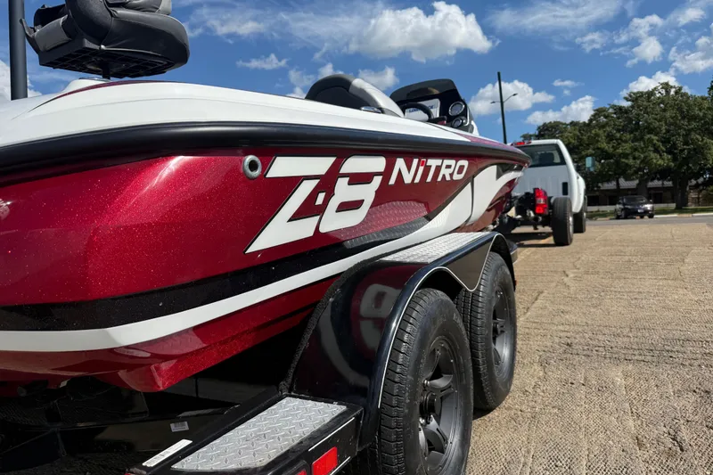 Slide: The Image of 2015 Nitro Z-8 boat cruising on a lake with trees in the background. - 54