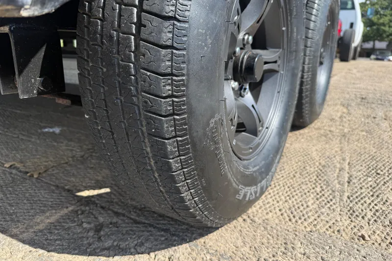 Slide: The Image of 2015 Nitro Z-8 boat on trailer, parked outdoors under a clear blue sky. - 55