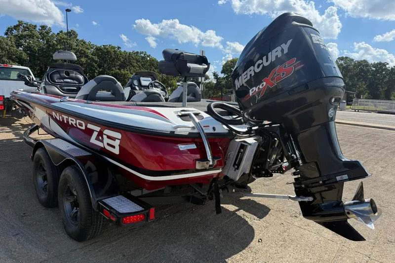 Slide: The Image of Mercury Pro XS engine on a 2015 Nitro Z-8 boat by a lake. - 59