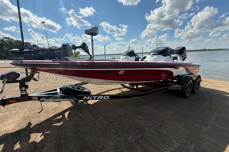 Slide: The Image of 2015 Nitro Z-8 boat on trailer by a lake under a cloudy sky. - 65
