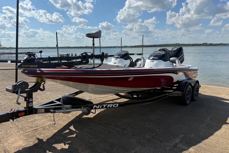 Slide: The Image of 2015 Nitro Z-8 boat on trailer by lake under blue sky. - 66