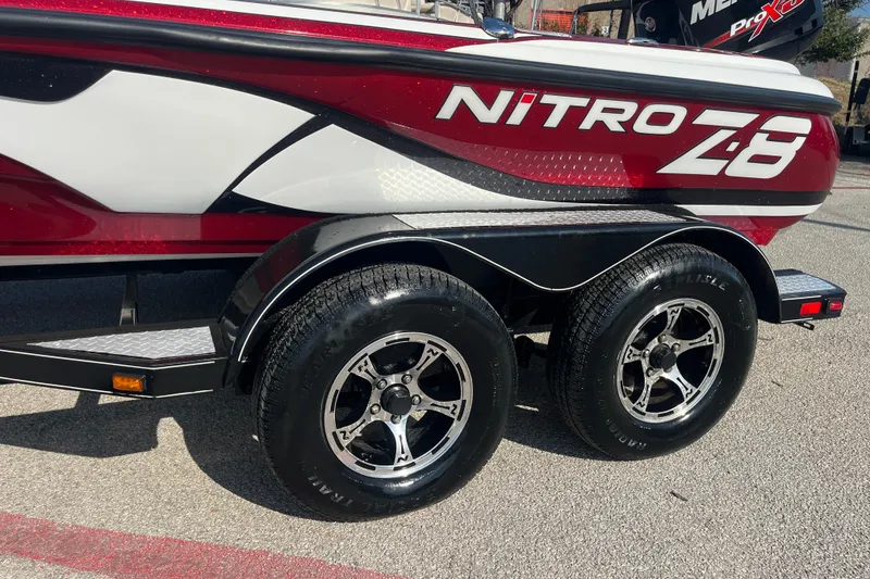 Slide: The Image of 2015 Nitro Z-8 boat on trailer by a lake under a blue sky. - 7