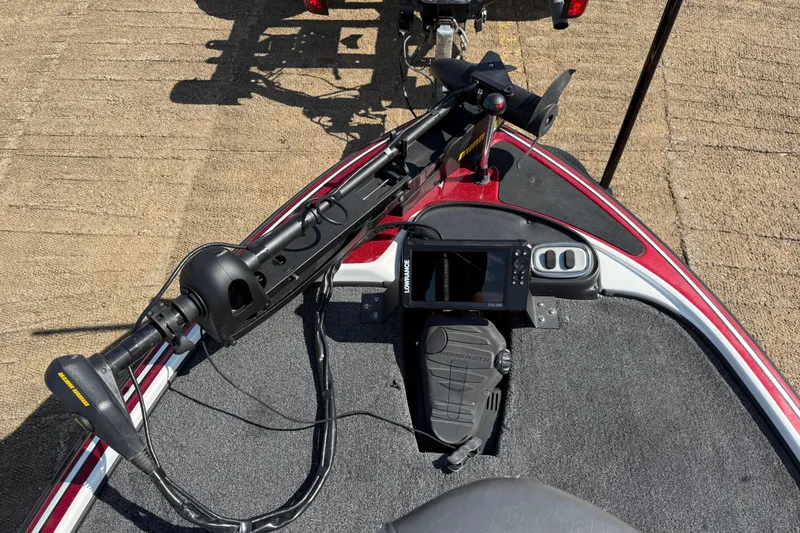 Slide: The Image of 2015 Nitro Z-8 boat seat with gray and red accents, near water. - 70