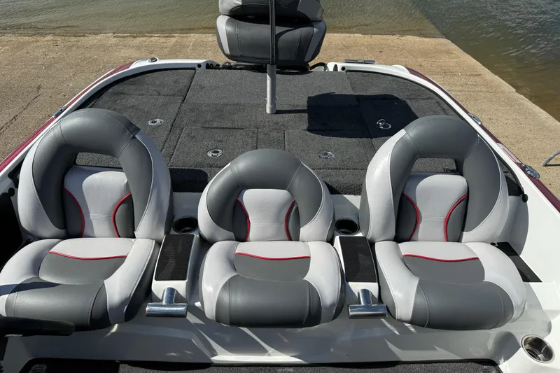 Slide: The Image of Gray and red boat seat in a 2015 Nitro Z-8 model, featuring cup holders. - 72