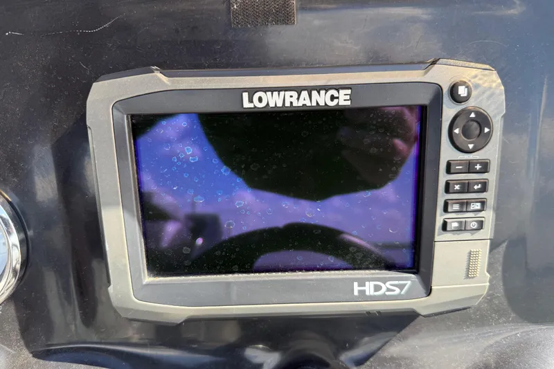 Slide: The Image of 2015 Nitro Z-8 boat with a fishing seat, docked by a serene lake. - 79