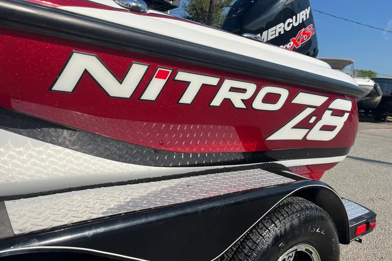 Slide: The Image of 2015 Nitro Z-8 boat trailer with dual wheels and sleek red design. - 8