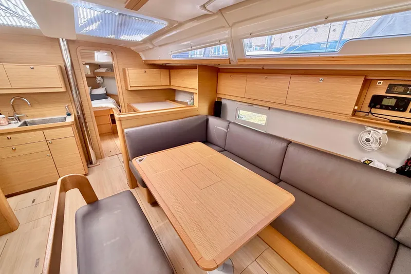 Slide: The Image of 2020 Dufour 430 yacht cockpit with wooden table and beige seating. - 12