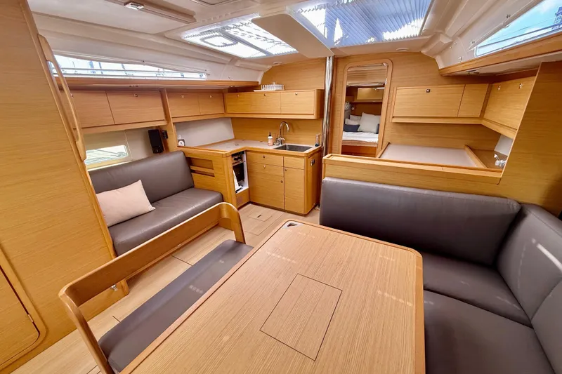 Slide: The Image of Luxurious interior of 2020 Dufour 430 yacht with modern wood finish and seating area. - 13