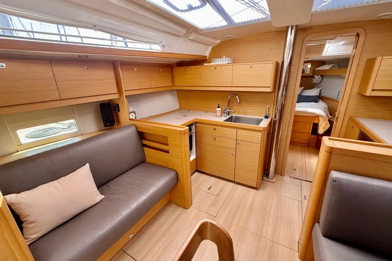 Slide: The Image of Modern interior of 2020 Dufour 430 yacht with wood finish and cozy seating area. - 14