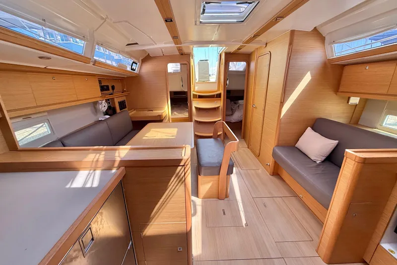 Slide: The Image of Modern interior of 2020 Dufour 430 yacht with wood finish and cozy seating area. - 16