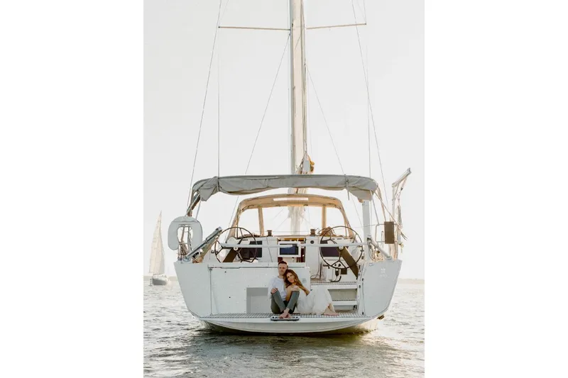 Slide: The Image of 2020 Dufour 430 sailboat cruising near coastal buildings with palm trees. - 2