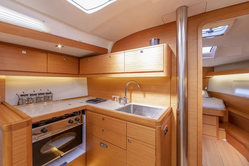 Slide: The Image of Modern interior of 2020 Dufour 430 yacht with wooden cabinetry and compact kitchen area. - 21