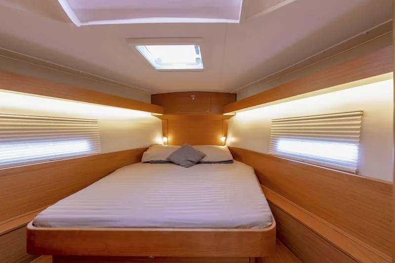 Slide: The Image of Interior of 2020 Dufour 430 yacht with modern wood finish and cozy seating area. - 24