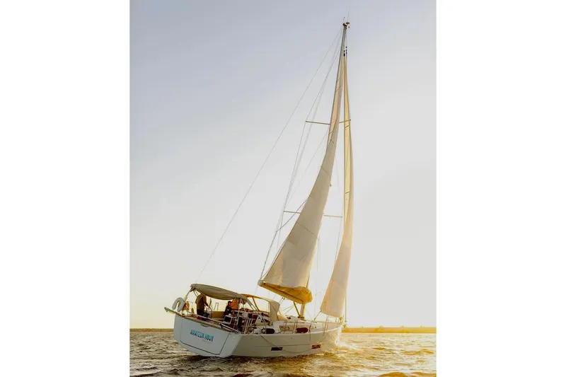 Slide: The Image of 2020 Dufour 430 sailboat on calm water under clear blue sky. - 3