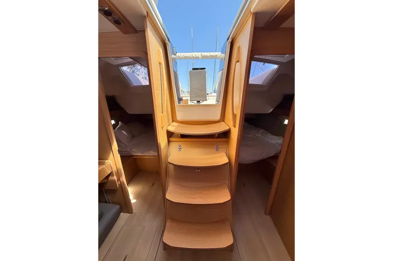 Slide: The Image of 2020 Dufour 430 sailboat docked at marina, featuring beige canopy and sleek design. - 33