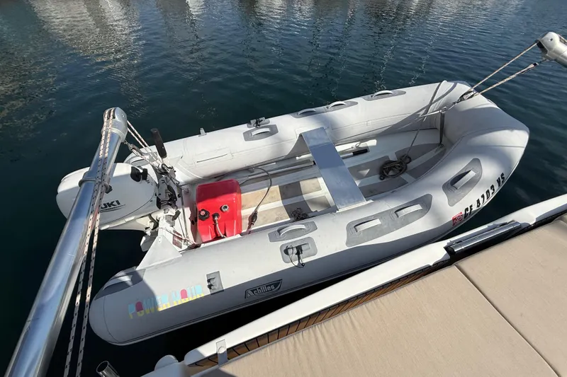 Slide: The Image of 2020 Dufour 430 sailboat with covered mainsail in a marina setting. - 49