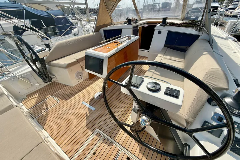 Slide: The Image of 2020 Dufour 430 sailboat docked in marina, showcasing sleek white hull design. - 7