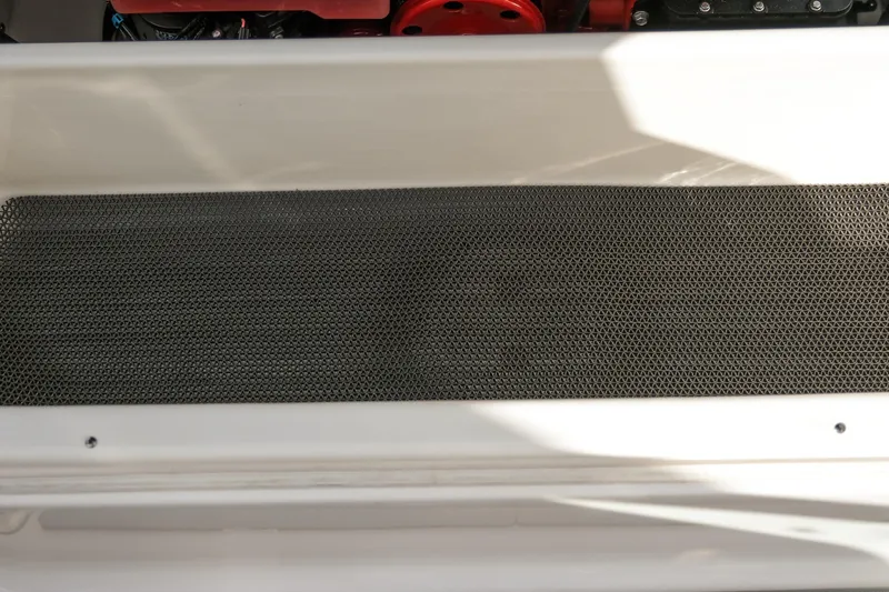 Slide: The Image of 2025 Chaparral 247 SSX boat engine compartment with protective mesh cover. - 23