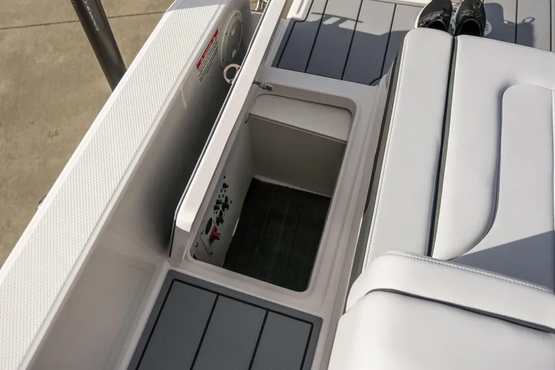 Slide: The Image of 2025 Chaparral 247 SSX boat interior storage compartment with sleek seating design. - 25