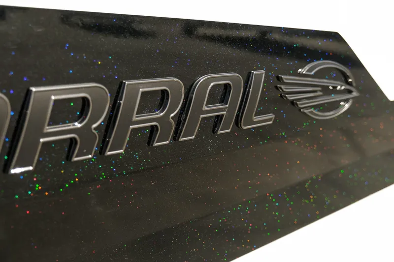 Slide: The Image of Close-up of 2025 Chaparral 247 SSX logo with glittery black finish. - 27