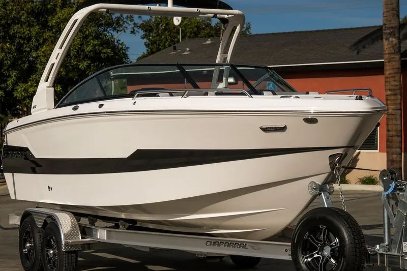Slide: The Image of 2025 Chaparral 247 SSX boat on trailer, sleek design, parked outdoors. - 3