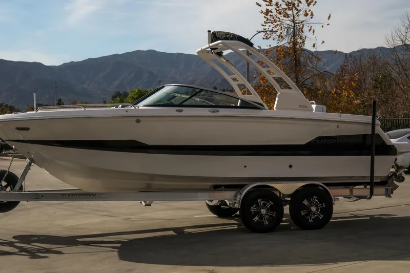 Slide: The Image of 2025 Chaparral 247 SSX boat on trailer, mountain backdrop, sunny day. - 6