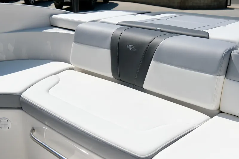 Slide: The Image of 2025 Chaparral 23 SSi boat interior seating, featuring sleek white and gray upholstery. - 18