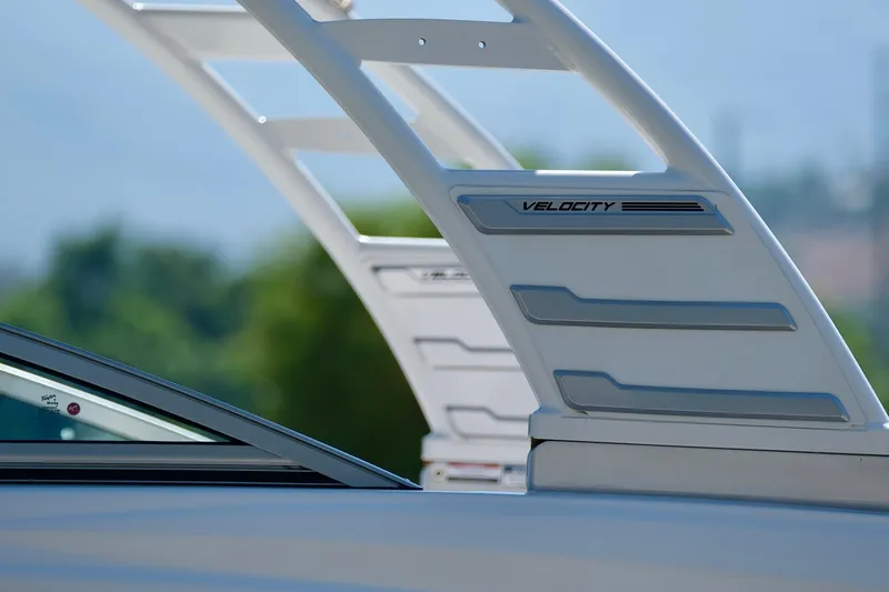Slide: The Image of Close-up of 2025 Chaparral 23 SSi boat's sleek design and Velocity branding. - 6